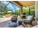 Inviting covered patio with a grill, seating, and a fire pit, perfect for outdoor enjoyment at 2000 Bloomsbury Run, Lake Mary, FL 32746