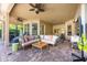 Spacious covered patio featuring a comfortable seating area, ceiling fans, and brick flooring at 2000 Bloomsbury Run, Lake Mary, FL 32746