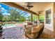 Screened-in outdoor pool area with comfortable seating, spa, and lush landscaping at 2000 Bloomsbury Run, Lake Mary, FL 32746