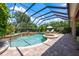 Beautiful screened-in pool and spa with waterfall feature and inviting lounge chairs at 2000 Bloomsbury Run, Lake Mary, FL 32746