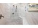 Elegant shower with marble tile, a rainfall shower head, and a built-in seat at 2000 Bloomsbury Run, Lake Mary, FL 32746