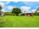 Large backyard with a metal carport providing covered parking for recreational vehicles and outdoor equipment at 20603 Paddock St, Orlando, FL 32833