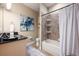 Bright bathroom featuring granite counters, a large vanity, and a tiled tub-shower combo at 20603 Paddock St, Orlando, FL 32833