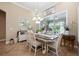 Cozy dining room featuring wainscotting, a chandelier, a farmhouse sign, and a large window at 20603 Paddock St, Orlando, FL 32833