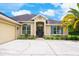 Welcoming home exterior with manicured landscaping, large windows, and an inviting front entrance at 20603 Paddock St, Orlando, FL 32833