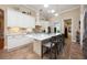 Bright kitchen featuring white cabinets, a large island with bar seating, and modern appliances at 20603 Paddock St, Orlando, FL 32833