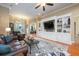 Cozy living room with hardwood floors, fireplace, built-in shelving, and comfortable seating arrangement at 20603 Paddock St, Orlando, FL 32833