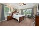 Spacious main bedroom with tray ceilings, neutral colors, and large windows at 20603 Paddock St, Orlando, FL 32833