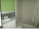 This bathroom features green walls, a shower-tub combo, toilet, sink, and vanity at 2112 Lee St, Orlando, FL 32805