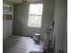 This bedroom has tile flooring and two windows bringing in natural light with walls ready to be painted at 2112 Lee St, Orlando, FL 32805