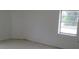This bedroom features neutral walls and tile flooring with natural light from the window at 2112 Lee St, Orlando, FL 32805