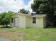 Side view of a light yellow home featuring the front door and ample windows, providing lots of light at 2112 Lee St, Orlando, FL 32805