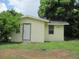 View of the side of a light yellow home, showcasing the home number next to the front door at 2112 Lee St, Orlando, FL 32805