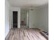 This living room has wood flooring, freshly painted walls, and a door leading into the bathroom at 2112 Lee St, Orlando, FL 32805