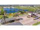 Aerial view of community entrance with a beautiful lake and fountain, surrounded by lush landscaping at 2114 Fleming Mist Pl, Kissimmee, FL 34747