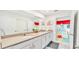 Bright bathroom with double vanity, and views into a bedroom featuring unique pokemon murals at 2114 Fleming Mist Pl, Kissimmee, FL 34747