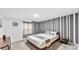 Stylish bedroom featuring a comfortable bed, accent wall, and modern nightstand at 2114 Fleming Mist Pl, Kissimmee, FL 34747