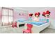 Playful ' bedroom features two twin beds, cartoon decor, and a cozy carpet at 2114 Fleming Mist Pl, Kissimmee, FL 34747