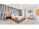 Inviting bedroom featuring a queen-size bed, accent wall, and modern decor at 2114 Fleming Mist Pl, Kissimmee, FL 34747