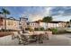 Exterior shot of building with outdoor fire pit surrounded by wooden chairs at 2114 Fleming Mist Pl, Kissimmee, FL 34747