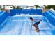 Enjoy wave riding on the FlowRider simulator for a unique surfing experience, fun for all ages at 2114 Fleming Mist Pl, Kissimmee, FL 34747