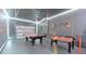 Spacious garage game room features a pool table, foosball, and LED lighting for entertainment at 2114 Fleming Mist Pl, Kissimmee, FL 34747