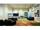 Fun game room with comfortable seating, TVs, and colorful wall designs at 2114 Fleming Mist Pl, Kissimmee, FL 34747