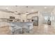 Modern kitchen with stainless steel appliances, an island with bar seating, and tile flooring at 2114 Fleming Mist Pl, Kissimmee, FL 34747