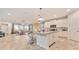 Open-concept kitchen with a center island, pendant lighting, and white cabinetry at 2114 Fleming Mist Pl, Kissimmee, FL 34747