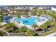 A stunning community pool surrounded by lush landscaping, cabanas, and plenty of seating for relaxation at 2114 Fleming Mist Pl, Kissimmee, FL 34747