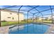 Inviting pool area featuring a screened enclosure, with an attached hot tub, and nice patio at 2114 Fleming Mist Pl, Kissimmee, FL 34747
