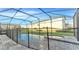 Screened pool area featuring a safety fence, a hot tub, and a lovely view of the home at 2114 Fleming Mist Pl, Kissimmee, FL 34747