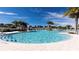 Beautiful community pool featuring palm trees, lounge chairs, and a serene atmosphere for relaxation at 2114 Fleming Mist Pl, Kissimmee, FL 34747