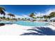 Large community pool with ample deck space, palm trees, and lounge chairs for residents at 2114 Fleming Mist Pl, Kissimmee, FL 34747
