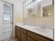 Bathroom features dual sinks, tiled floors, and outdoor access at 2151 Conifer Ave, Winter Park, FL 32792