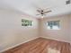 Cozy bedroom with hardwood floors, natural light, and a ceiling fan at 2151 Conifer Ave, Winter Park, FL 32792