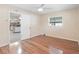 Bedroom features hardwood floors and view into kitchen area at 2151 Conifer Ave, Winter Park, FL 32792