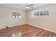 Bright bedroom with hardwood floors, ceiling fan, and natural light from two windows at 2151 Conifer Ave, Winter Park, FL 32792