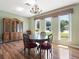 Charming dining area with elegant chandelier, hardwood floors, and multiple bright windows at 2151 Conifer Ave, Winter Park, FL 32792