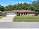 Charming single-story home featuring a two-car garage and well-manicured lawn at 2151 Conifer Ave, Winter Park, FL 32792