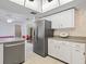 Spacious kitchen with stainless steel refrigerator and views into the dining area at 2151 Conifer Ave, Winter Park, FL 32792