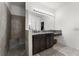 Bathroom featuring walk-in shower, single vanity, and large mirror with modern lighting at 2275 Pearl Cider St, Orlando, FL 32824