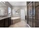 Bathroom featuring a granite countertop, tile shower, and separate soaking tub perfect for relaxation at 2275 Pearl Cider St, Orlando, FL 32824