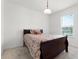 Bedroom features a dark wood frame bed with a window that lets in natural light at 2275 Pearl Cider St, Orlando, FL 32824