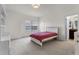 Bright bedroom with white furnishings, plush carpet, and a window bringing in lots of natural light at 2275 Pearl Cider St, Orlando, FL 32824