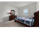 Cozy bedroom with a neat bed, dark wooden furniture, and a window with natural light at 2275 Pearl Cider St, Orlando, FL 32824