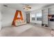 This large room includes built-in shelving and a cozy couch against a wall with a bold 'A' graphic at 2275 Pearl Cider St, Orlando, FL 32824