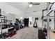 Home gym with an array of exercise equipment, mirrors, and carpet flooring at 2275 Pearl Cider St, Orlando, FL 32824