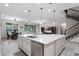 Bright kitchen features a large island with pendant lighting and stainless steel appliances at 2275 Pearl Cider St, Orlando, FL 32824