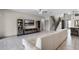 Open-concept living room features tile floors, staircase, and access to the kitchen at 2275 Pearl Cider St, Orlando, FL 32824